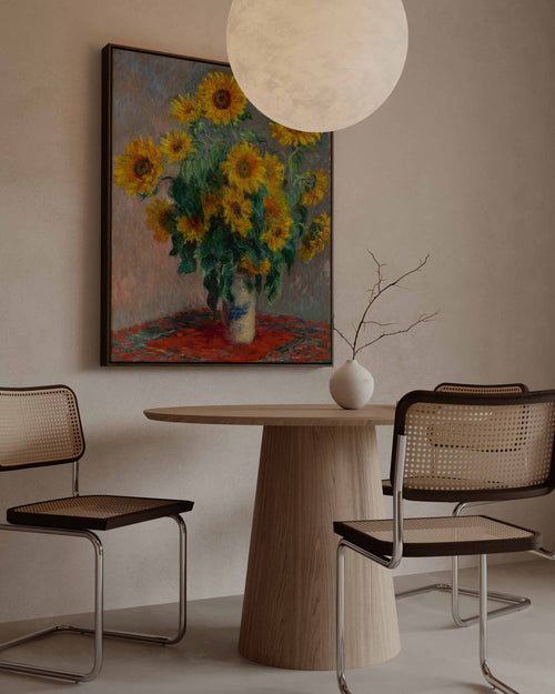 Dining room with a round wooden table, chairs, and a sunflower painting on the wall. High quality canvas with wooden frame Claude monet painting