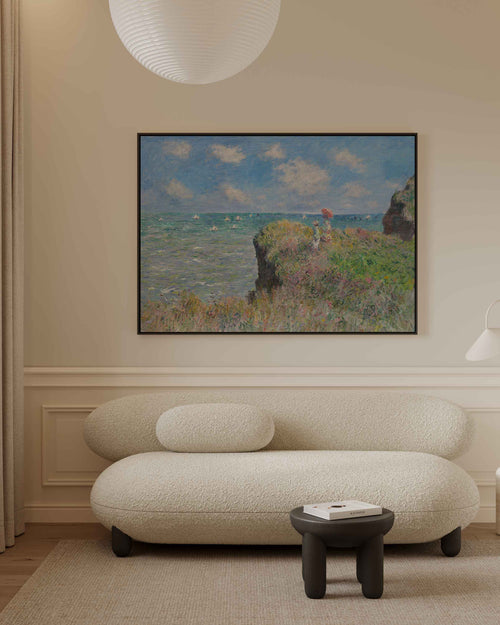 Modern living room with a textured sofa, small table, and framed artwork on the wall. Claude Monet printed on Canvas with Black wooden frame