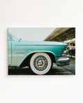 Horizontal canvas wall art featuring a vintage blue classic American car with chrome details and whitewall tires. Printed on high quality canvas
