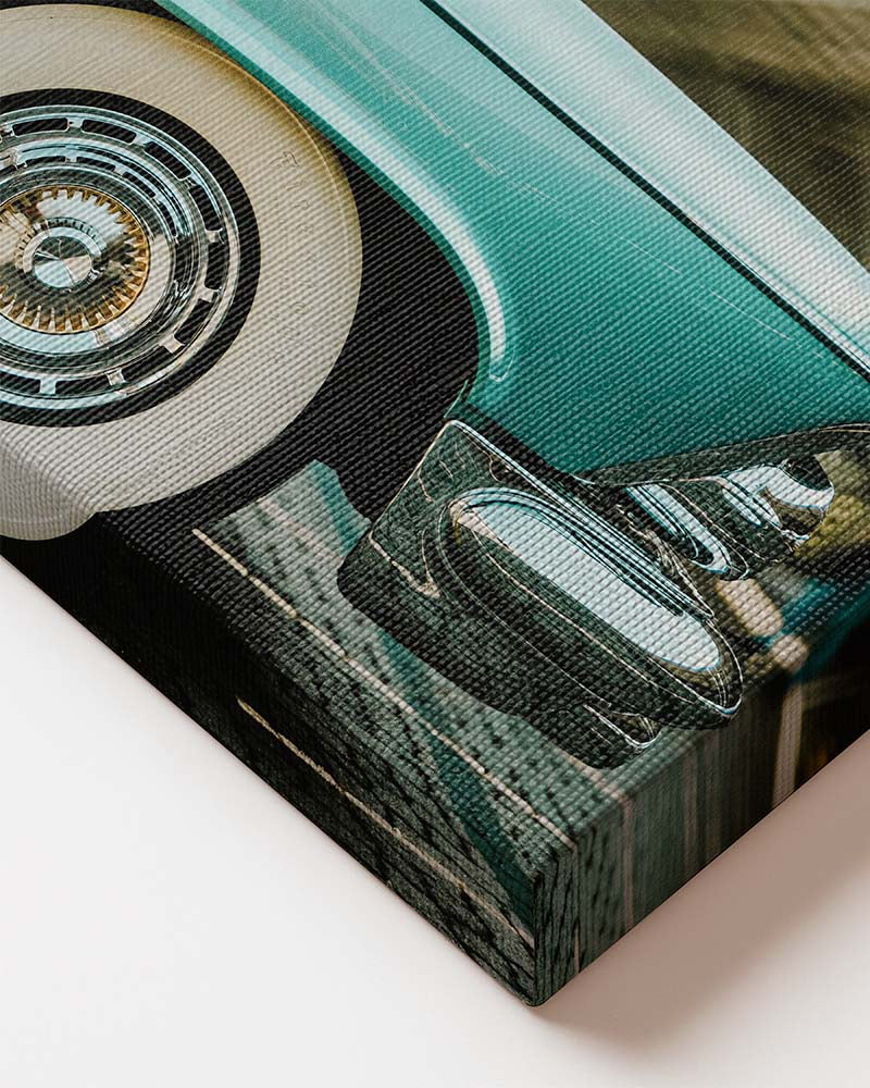 Horizontal canvas wall art featuring a vintage blue classic American car with chrome details and whitewall tires. Printed on high quality canvas close up of premium material
