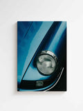 Vertical canvas wall art featuring a close-up of a blue vintage sports car with classic round headlight and retro design details. Printed n high quality canvas